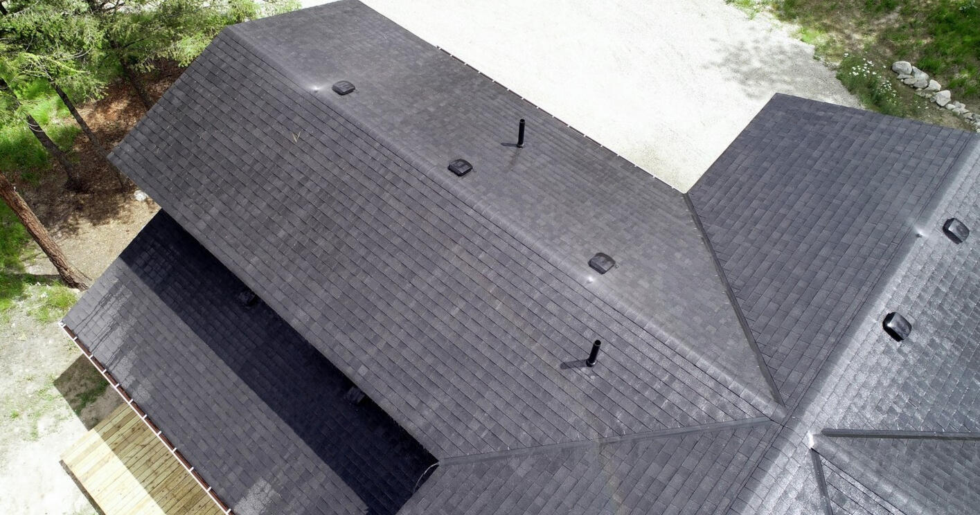 A typical rooftop with all sprinklers operating and soaking the roof and deck This is a 4 on 12 asphalt shingled roof